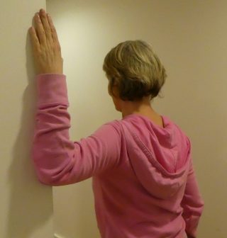 Stretching against a wall