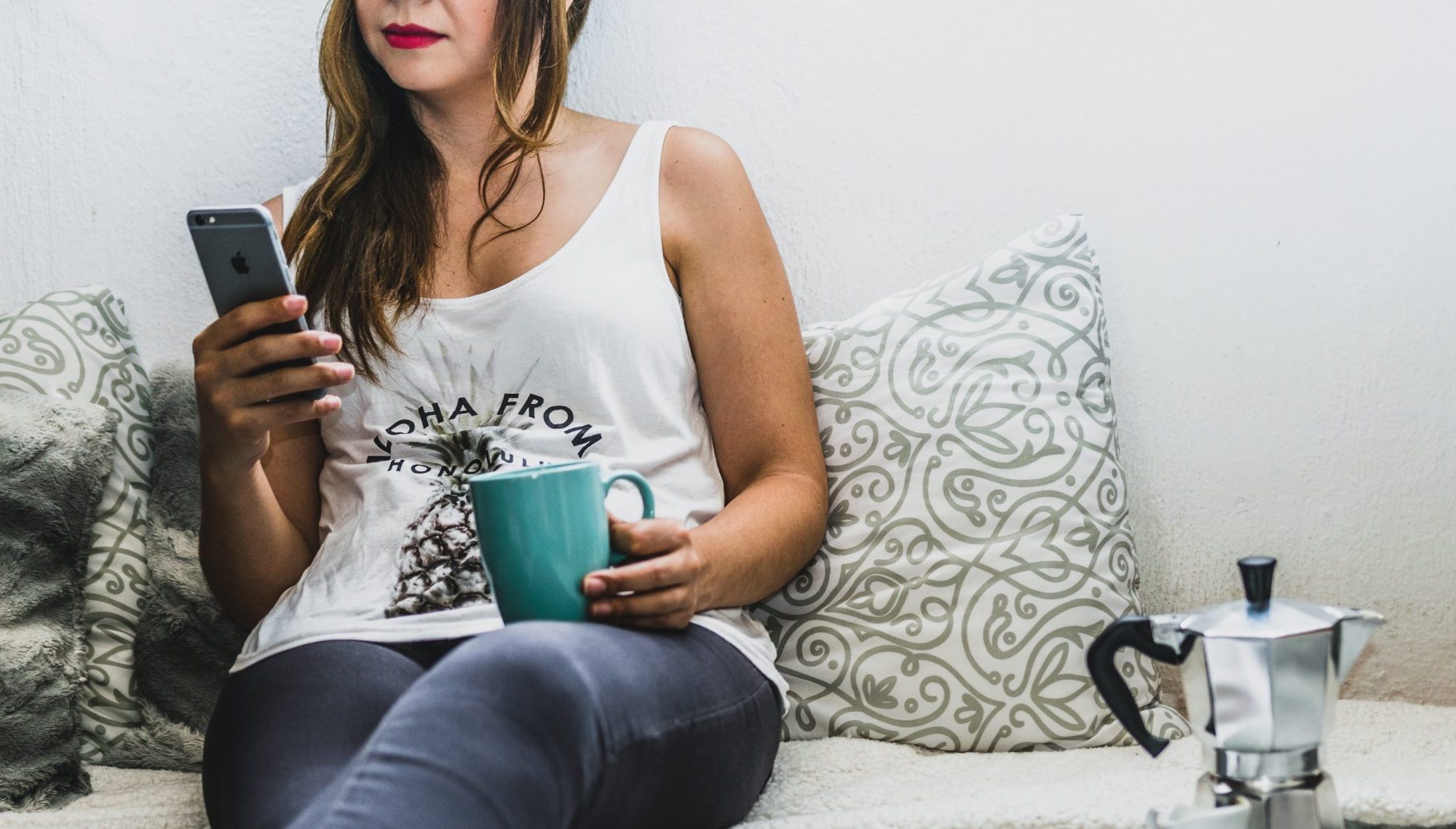 Woman with coffee and phone