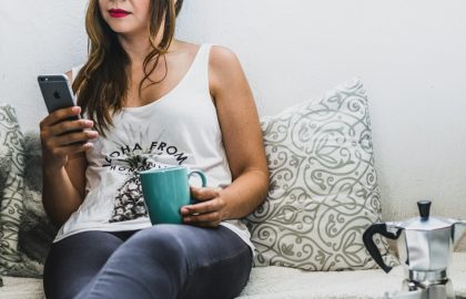 Woman with coffee and phone